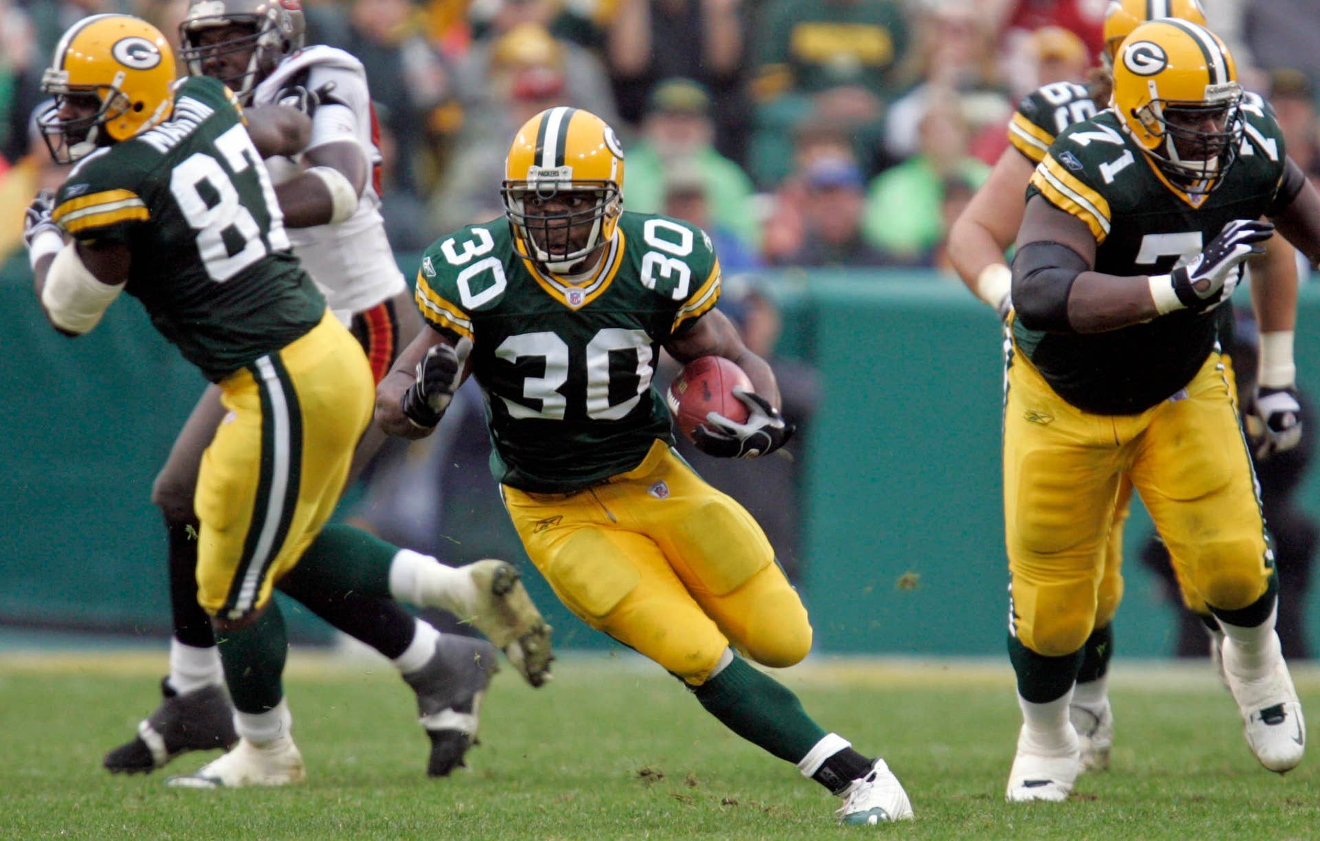 Green Bay Packers running back Ahman Green runs though a hole in the Tampa Bay Buccanneers' defense at Lambeau Field.