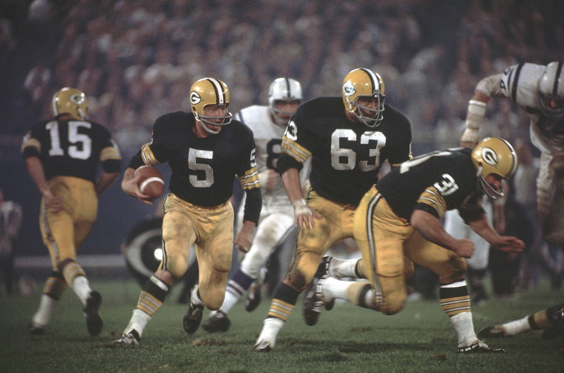 Green Bay Packers running back Paul Hornung in action, rushing behind Jim Taylor and Fuzzy Thurston vs. the Baltimore Colts at Lambeau Field.