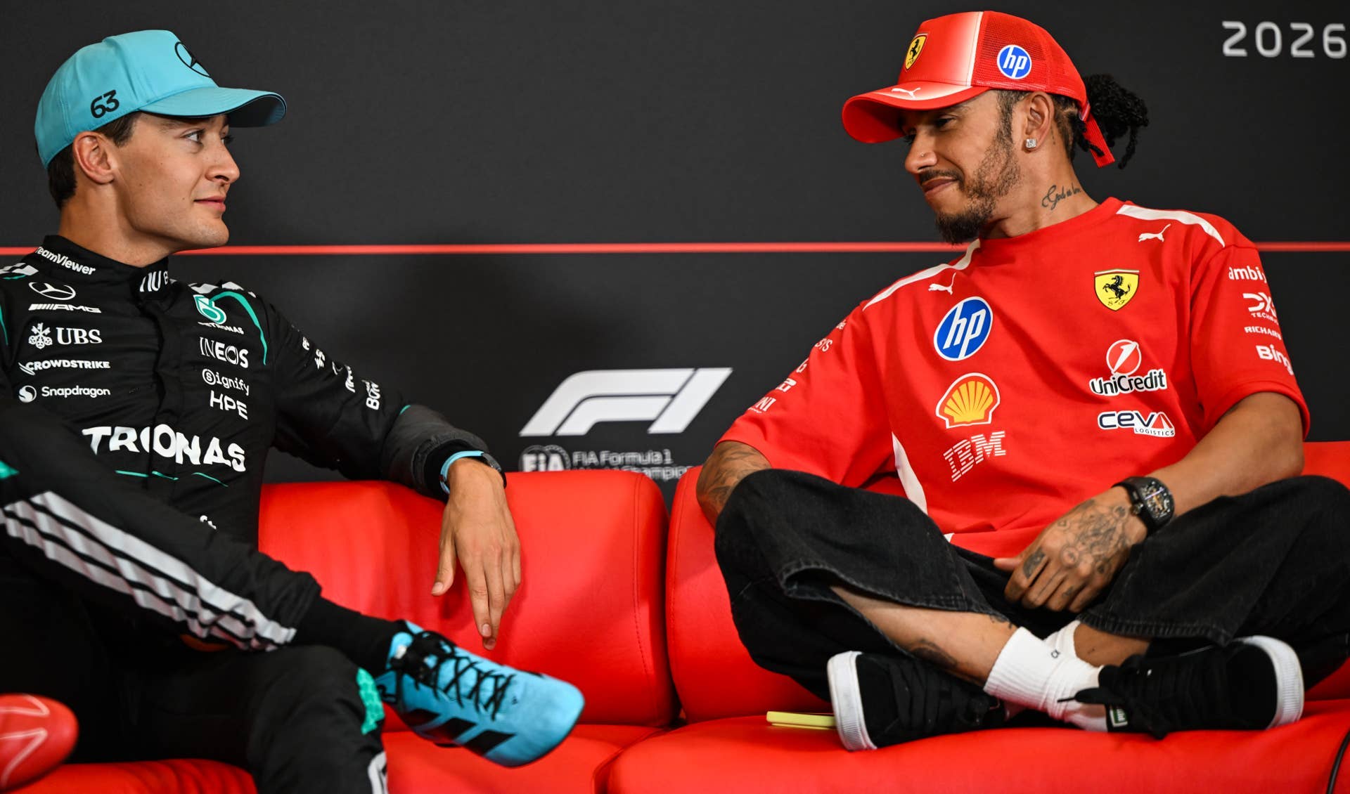 Lewis Hamilton in his 2026 racing suit celebrating after a successful points-scoring race weekend.