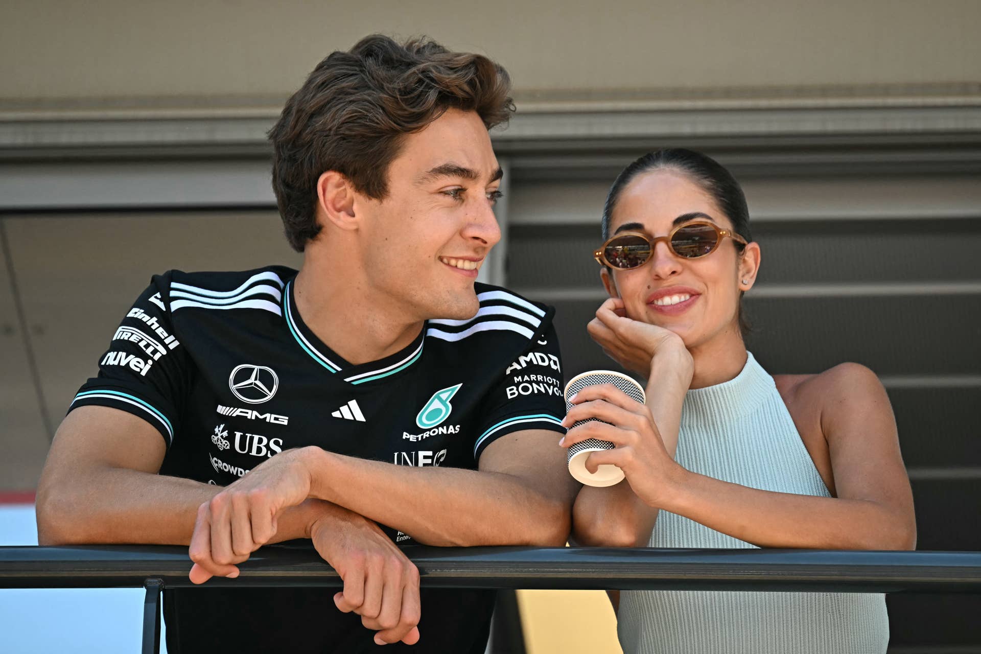 Mercedes' British driver George Russell and his girlfriend Carmen Montero Mundt look on from a balcony ahead of the Formula One Monaco Grand Prix.