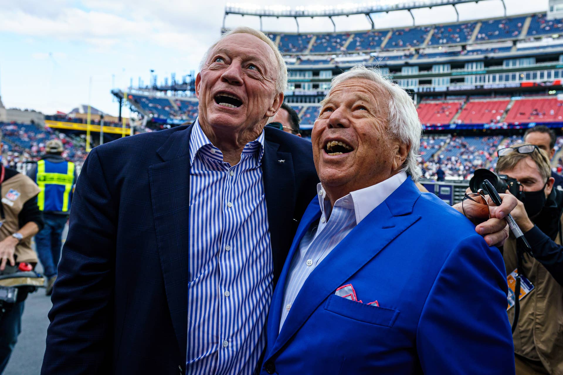Dallas cowboys owner Jerry Jones and New England Patriots owner Robert Kraft meet before an NFL game at Gillette Stadium.