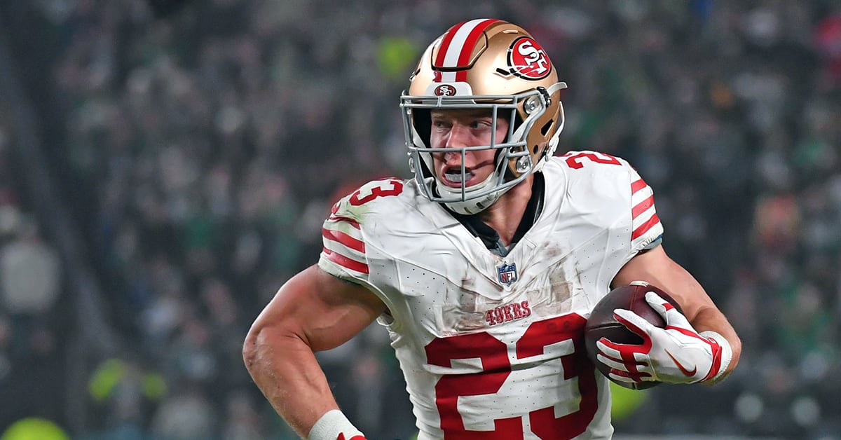Christian McCaffrey running with the football during an NFL game, wearing a white uniform with red and gold details, showcasing power and agility.