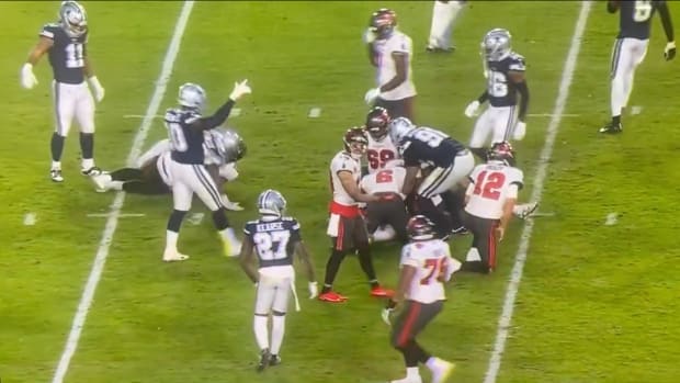 Tom Brady attempts to slide tackle a Cowboys' defender