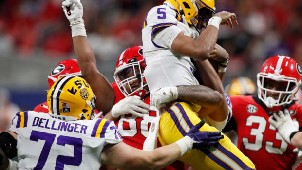 Georgia defensive lineman Jalen Carter (88) holds LSU quarterback Jayden Daniels (5) in the air in celebration after sacking Daniels during the first half of the SEC Championship NCAA college football game between LSU and Georgia in Atlanta, on Saturday, Dec. 3, 2022. News Joshua L Jones