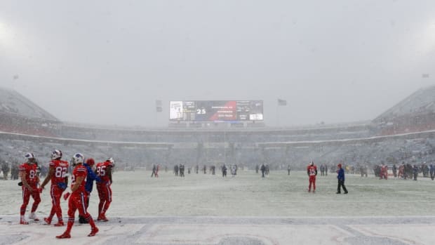 Snow falls at the Buffalo Bills game.
