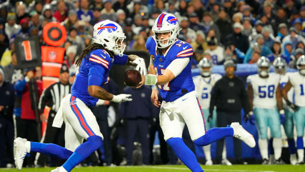 Dec 17, 2023; Orchard Park, New York, USA; Buffalo Bills quarterback Josh Allen (17) handles the ball off to running back James Cook (4) in the first half against the Dallas Cowboys at Highmark Stadium.