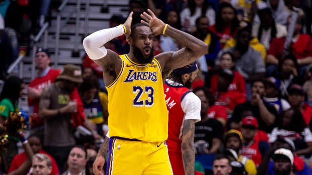 Apr 16, 2024; New Orleans, Louisiana, USA; Los Angeles Lakers forward LeBron James (23) reacts to a play call against New Orleans Pelicans forward Brandon Ingram (14) during the second half of a play-in game of the 2024 NBA playoffs at Smoothie King Center. Mandatory Credit: Stephen Lew-USA TODAY Sports