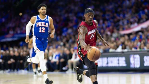Apr 17, 2024; Philadelphia, Pennsylvania, USA; Miami Heat forward Jimmy Butler (22) dribbles the ball past Philadelphia 76ers forward Tobias Harris (12) during the first quarter of a play-in game of the 2024 NBA playoffs at Wells Fargo Center.