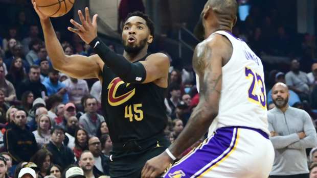 Cleveland Cavaliers guard Donovan Mitchell (45) drives to the basket against Los Angeles Lakers forward LeBron James (23) during the first half at Rocket Mortgage FieldHouse. 