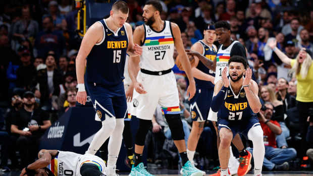 Apr 19, 2023; Denver, Colorado, USA; Denver Nuggets guard Jamal Murray (27) reacts after a play with Minnesota Timberwolves guard Mike Conley (10) as center Nikola Jokic (15) and center Rudy Gobert (27) look on in the fourth quarter during game two of the 2023 NBA Playoffs at Ball Arena.