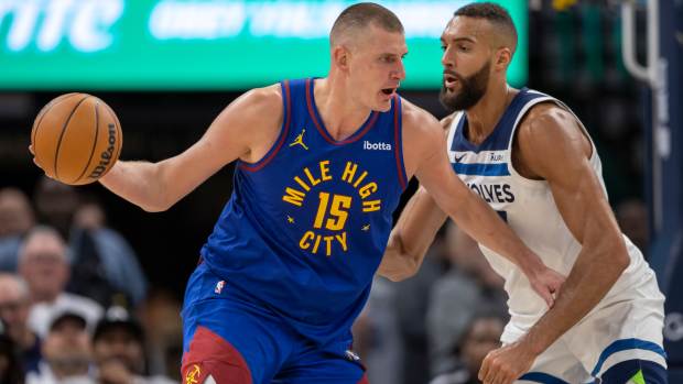 Denver Nuggets center Nikola Jokic (15) controls the ball as Minnesota Timberwolves center Rudy Gobert (27) defends in the second half during game three of the second round for the 2024 NBA playoffs at Target Center