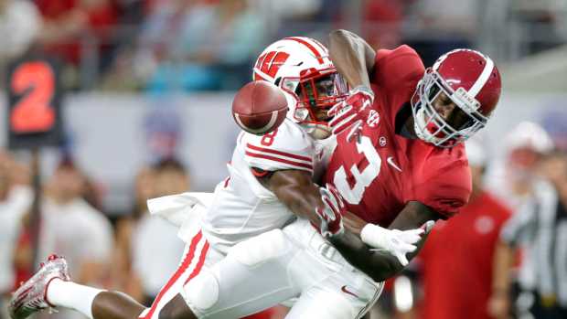 Wisconsin Badgers cornerback Sojourn Shelton (8) breaks up a long pass intended for Alabama Crimson Tide wide receiver Calvin Ridley during a 2015 game.