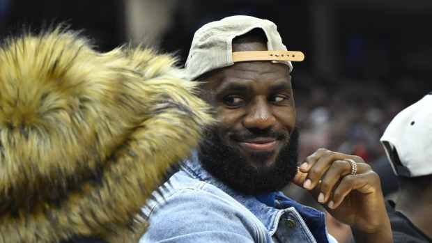 May 13, 2024; Cleveland, Ohio, USA; Los Angeles Lakers forward LeBron James looks at his wife Savannah James in the second quarter of game four of the second round for the 2024 NBA playoffs between the Cleveland Cavaliers and the Boston Celtics at Rocket Mortgage FieldHouse.