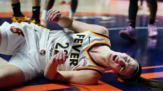 May 14, 2024; Uncasville, Connecticut, USA; Indiana Fever guard Caitlin Clark (22) falls to the floor after a blocked shot by guard Rachel Banham (1) (not pictured) in the second quarter at Mohegan Sun Arena.