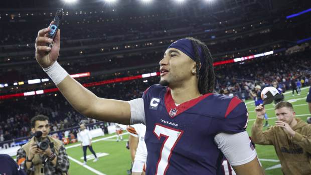 Jan 13, 2024; Houston, Texas, USA; Houston Texans quarterback C.J. Stroud (7) holds a phone on the field after a 2024 AFC wild card game against the Cleveland Browns at NRG Stadium.