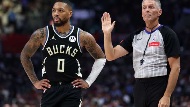 Mar 10, 2024; Los Angeles, California, USA; Milwaukee Bucks guard Damian Lillard (0) stands next to a referee Scott Foster (48) during the third quarter against the Los Angeles Clippers at Crypto.com Arena.