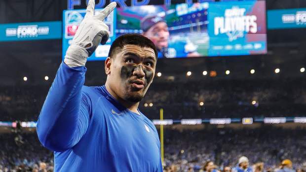 Detroit Lions offensive tackle Penei Sewell signals for two more wins as he celebrates the 31-23 victory over the Tampa Bay Buccaneers in the NFC divisional round playoff game at Ford Field in Detroit on Sunday, Jan. 21, 2024.  