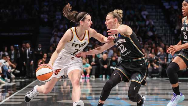 May 18, 2024; Brooklyn, New York, USA; Indiana Fever guard Caitlin Clark (22) looks to drive past New York Liberty guard Courtney Vandersloot (22) in the first quarter at Barclays Center.