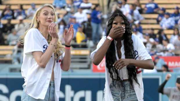 Los Angeles Sparks Cameron Brink (22) and Rickea Jackson (2) react after throwing out the first pitch prior to the game between the Los Angeles Dodgers and the Arizona Diamondbacks at Dodger Stadium.