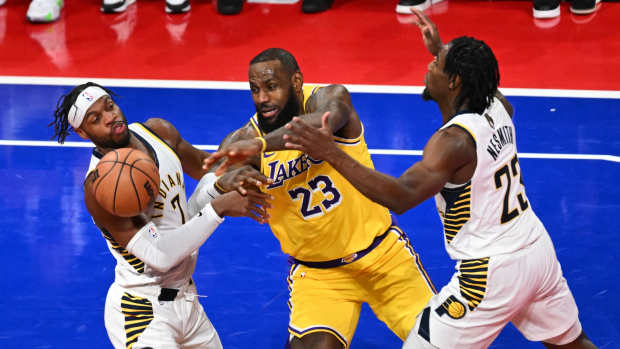 Dec 9, 2023; Las Vegas, Nevada, USA; Los Angeles Lakers forward LeBron James (23) chases a loose ball against Indiana Pacers guard Buddy Hield (7) and forward Aaron Nesmith (23) during the second quarter of the NBA In-Season Tournament Championship game at T-Mobile Arena.