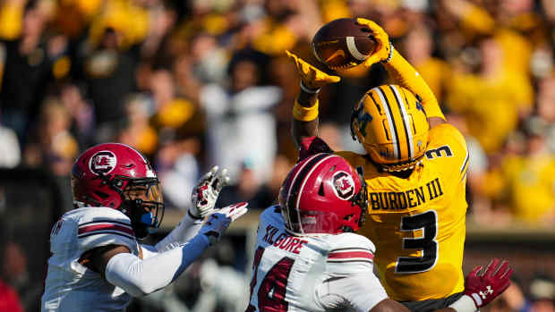 Oct 21, 2023; Columbia, Missouri, USA; Missouri Tigers wide receiver Luther Burden III (3) catches a touchdown pass against South Carolina Gamecocks defensive back Jalon Kilgore (24) and defensive back DQ Smith (1) during the first half at Faurot Field at Memorial Stadium.