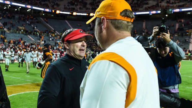 Nov 13, 2021; Knoxville, Tennessee, USA; Georgia Bulldogs head coach Kirby Smart (left) and Tennessee Volunteers head coach Josh Heupel (right) meet at midfield after the game at Neyland Stadium.