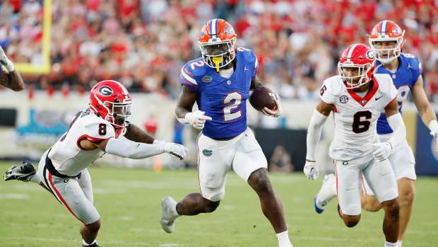 Oct 28, 2023; Jacksonville, Florida, USA; Florida Gators running back Montrell Johnson Jr. (2) runs the bal against Georgia Bulldogs defensive back Joenel Aguero (8) and defensive back Daylen Everette (6) in the second half at EverBank Stadium.