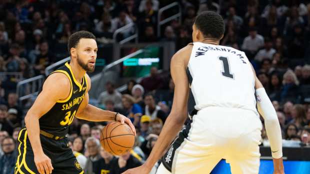 Golden State Warriors guard Stephen Curry (30) dribbles the basketball against San Antonio Spurs center Victor Wembanyama (1) - (NBA)