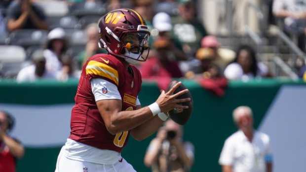 Aug 10, 2024; East Rutherford, New Jersey, USA; Washington Commanders quarterback Marcus Mariota (0) receives a snap during the first quarter against the New York Jets at MetLife Stadium. Mandatory Credit: Lucas Boland-USA TODAY Sports