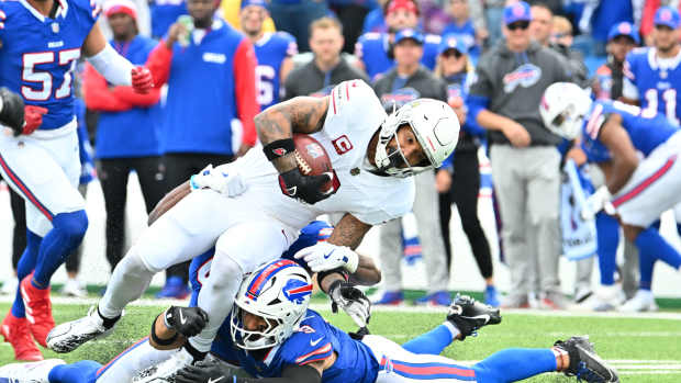 Sep 8, 2024; Orchard Park, New York, USA; Arizona Cardinals running back James Conner (6) runs against Buffalo Bills linebacker Dorian Williams (42) in the first quarter at Highmark Stadium.