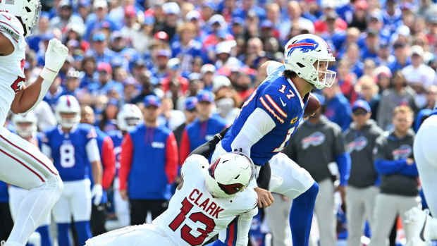 Sep 8, 2024; Orchard Park, New York, USA; Buffalo Bills quarterback Josh Allen (17) is tackled by Arizona Cardinals cornerback Kei'Trel Clark (13) in the second quarter at Highmark Stadium.