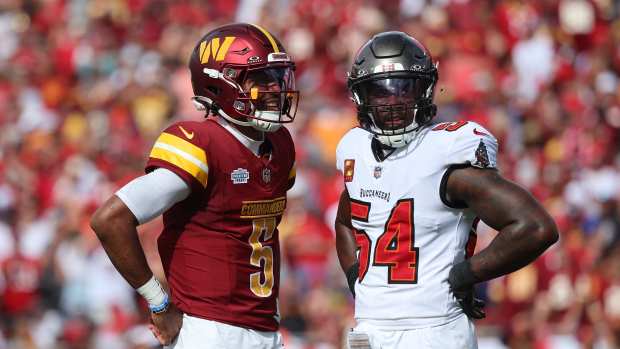 Sep 8, 2024; Tampa, Florida, USA; Washington Commanders quarterback Jayden Daniels (5) and Tampa Bay Buccaneers linebacker Lavonte David (54) look on during the first half at Raymond James Stadium.