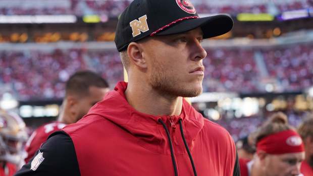 San Francisco 49ers running back Christian McCaffrey watches from the sideline against the New York Jets.