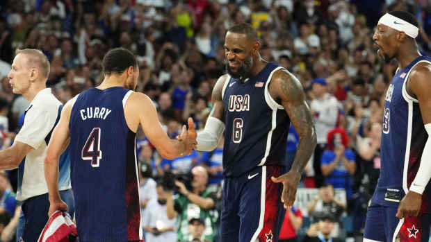 Paris, France; United States shooting guard Stephen Curry (4) and guard LeBron James (6) celebrate after defeating France in the men's basketball gold medal game during the Paris 2024 Olympic Summer Games at Accor Arena - Rob Schumacher-Imagn Images