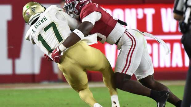 Alabama Crimson Tide linebacker Justin Jefferson (15) tackles South Florida Bulls quarterback Byrum Brown