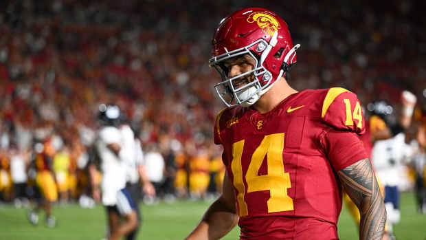 Los Angeles, California, USA; USC Trojans quarterback Jayden Maiava (14) scores a touchdown against the Utah State Aggies during the fourth quarter at United Airlines Field at Los Angeles Memorial Coliseum - Jonathan Hui-Imagn Images