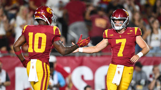 Los Angeles, California, USA; USC Trojans quarterback Miller Moss (7) celebrates with USC Trojans wide receiver Kyron Hudson (10) after scoring a touchdown against Utah State Aggies during the first quarter at United Airlines Field at Los Angeles Memorial Coliseum - Jonathan Hui-Imagn Images