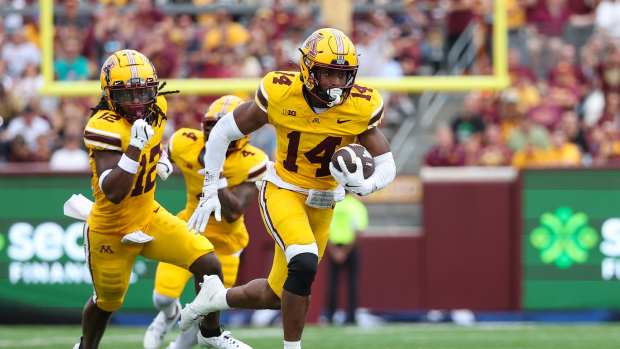 Sep 14, 2024; Minneapolis, Minnesota, USA; Minnesota Golden Gophers defensive back Kerry Brown (14) runs the ball after intercepting a pass against the Nevada Wolf Pack during the first half at Huntington Bank Stadium.