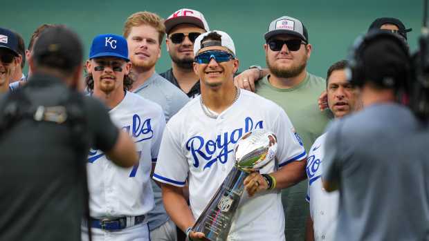 Kansas City Chiefs quarterback Patrick Mahomes poses for a photo with teammates prior to a game between the Cincinnati Reds and the Kansas City Royals at Kauffman Stadium. 