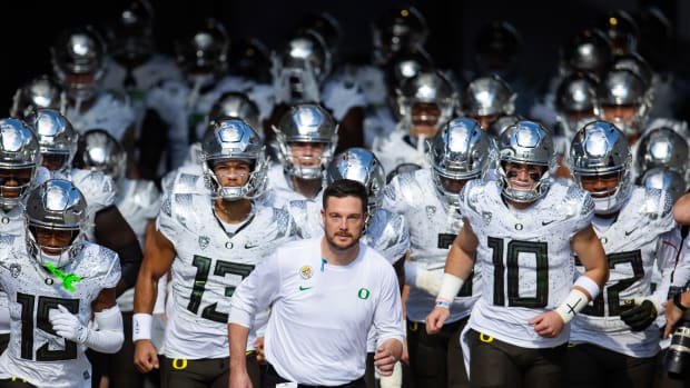 Nov 18, 2023; Tempe, Arizona, USA; Oregon Ducks head coach Dan Lanning (center) leads quarterback Bo Nix (10) and Ty Thompson (13) onto the field for the game against the Arizona State Sun Devils at Mountain America Stadium. Mandatory Credit: Mark J. Rebilas-USA TODAY Sports