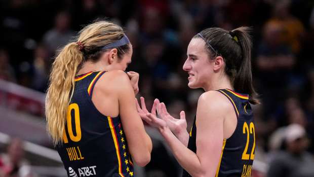 Indiana Fever guard Caitlin Clark talks with teammate Lexie Hull.