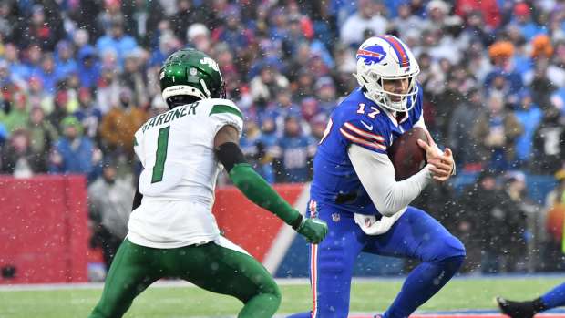 Buffalo Bills quarterback Josh Allen (17) runs the ball against New York Jets cornerback Sauce Gardner (1).