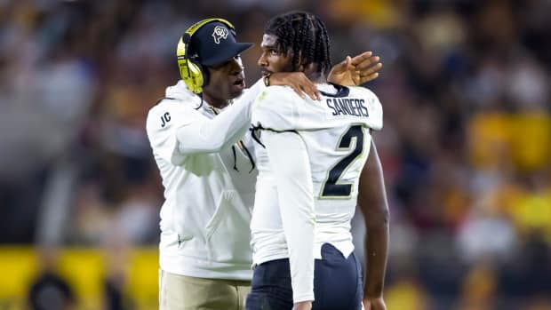 Colorado Buffaloes head coach Deion Sanders with son and quarterback Shedeur Sanders (2) against the Arizona State Sun Devils at Mountain America Stadium.