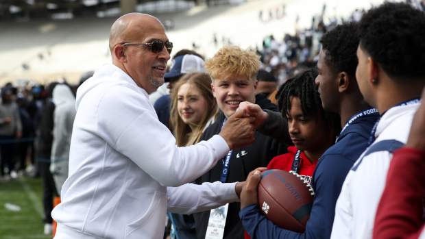 Apr 26, 2025; University Park, PA, USA; Penn State Nittany Lions head coach James Franklin interacts with recruits following the Blue White spring game at Beaver Stadium. The White team defeated the Blue team 10-8.
