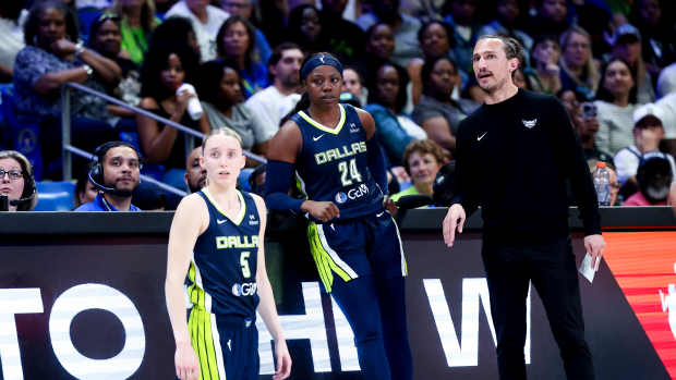 Dallas Wings guards Paige Bueckers (5) and Arike Ogunbowale (24) and head coach Chris Koclanes during a game against the Minnesota Lynx.