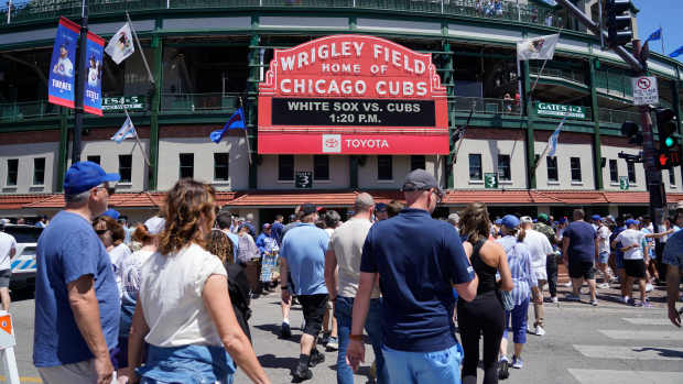 Fans walk to the ballpark before a game between the Chicago Cubs and the Chicago White Sox at Wrigley Field.