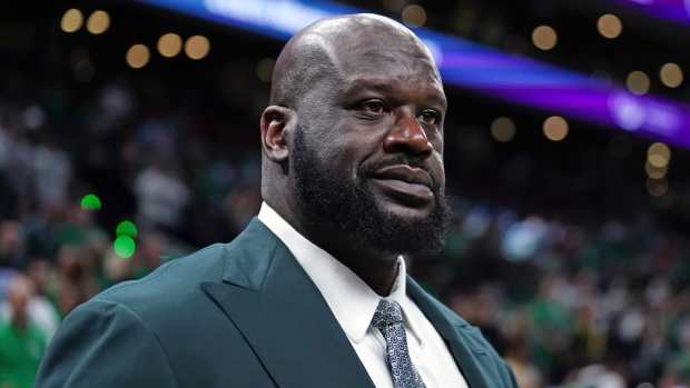 NBA legend Shaquille O'Neal looks on while attending a game.