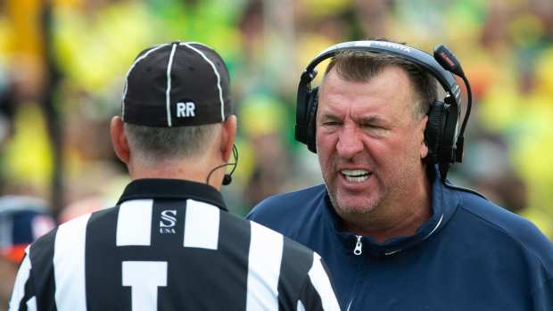 Illinois coach Bret Bielema has words with an official during the first half at Autzen Stadium.