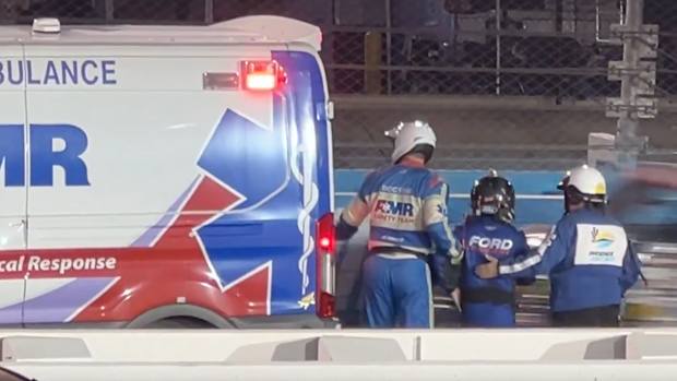 Frankie Muniz leaves the track in an ambulance.