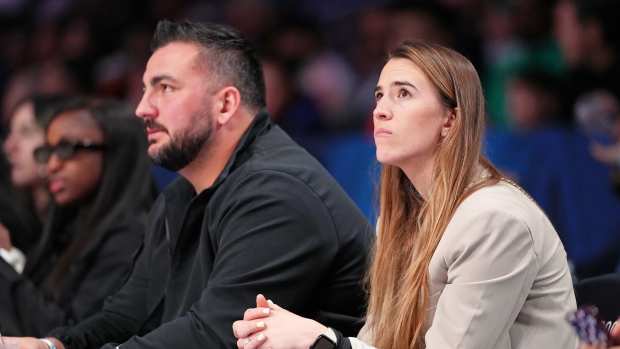  New York Liberty guard Sabrina Ionescu and Las Vegas Raiders offensive lineman Hroniss Grasu look on during the second half of the 73rd NBA All Star game at Gainbridge Fieldhouse. Mandatory Credit: Kyle Terada-Imagn Images